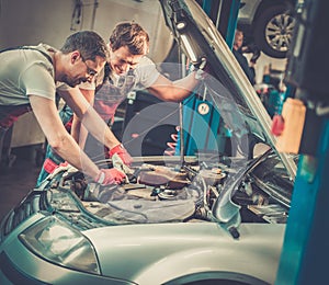 Servicemen in a car workshop