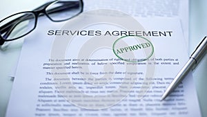 Services agreement approved, seal stamped on official document, business deal