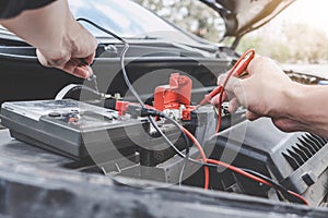 Services car engine machine concept, Automobile mechanic repairman hands checking a car engine automotive workshop with digital