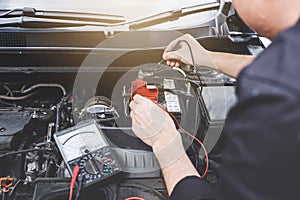 Services car engine machine concept, Automobile mechanic repairman hands checking a car engine automotive workshop with digital