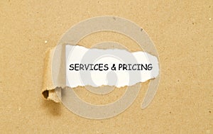 Services and pricing written under torn paper.