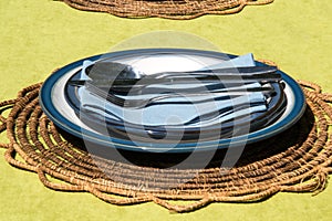 Serving blue plates and cutlery (knives, forks, spoons)