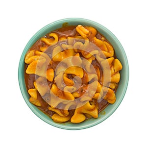 Serving of canned pasta lasagna in bowl on white background