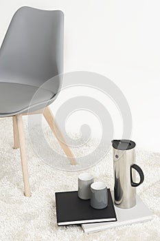 Serving of coffee alongside a modern chair