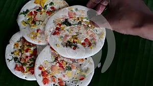 Serving colourful south Indian uttapam with coconut, green chili chutney