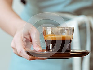 Serving a delicious cup of coffee with white foam photo