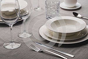 Serving dinnerware with cutlery and glasses