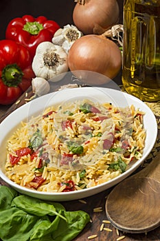 Serving dish with orzo and roasted red peppers