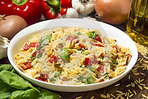 Serving dish with orzo and roasted red peppers