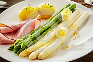 Serving of fresh green and canned white asparagus