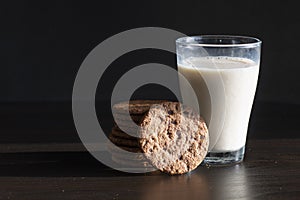 Serving healthy morning breakfast with a fresh milk in a glass and Pile of Delicious Chocolate homemade Chip Cookies on a vintage