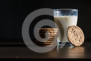 Serving healthy morning breakfast with a fresh milk in a glass and Pile of Delicious Chocolate homemade Chip Cookies on a vintage
