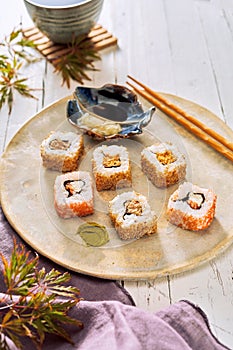 Serving of healthy uramaki sushi with soy sauce