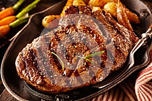 Serving of marinated rib eye steak with potatoes