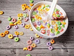 Serving milk in a white bowl with colorful sugary cereal