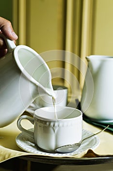 Serving milk in a white ceramic cup