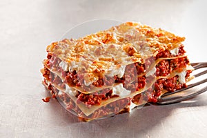 Serving a portion of Italian lasagne