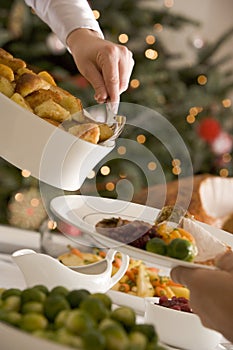 Serving Roast Potatoes at Christmas Lunch