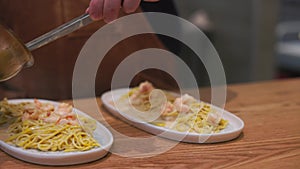 Serving and serving pasta in a restaurant. Italian pasta on a plate. Popular Italian food. tasty food, high haute