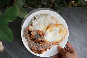 Sunny side up egg and stir fried park with chilli paste and rice