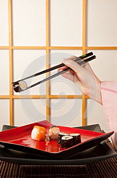 Serving sushi with chopsticks