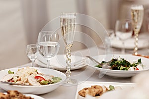 Serving table of a variety of delicious festive food and wine prepared for event party or wedding. selective focus