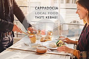 Serving of traditional Cappadocia turkish food from pottery kebab