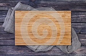 Serving tray over old wooden table, cutting board on dark wood background, top view