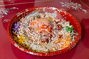 Serving of yusheng or yee sang with raw salmon during Chinese New Year believed to bring good luck and prosperity