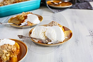 Servings of Drop Biscuit Peach Cobbler with Ice Cream