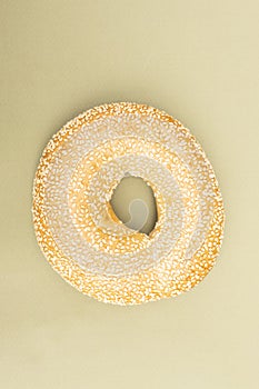 Sesame bagel isolated on green