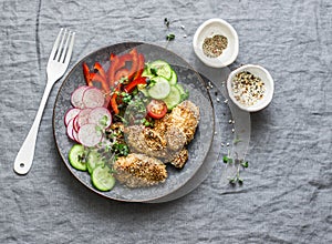 Sesame breading teriyaki baked chicken breast and fresh vegetables. Baked chicken and tomatoes, cucumbers, peppers, radishes, micr