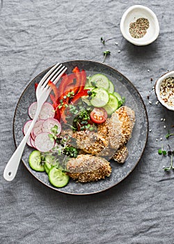 Sesame breading teriyaki baked chicken breast and fresh vegetables. Baked chicken and tomatoes, cucumbers, peppers, radishes, micr