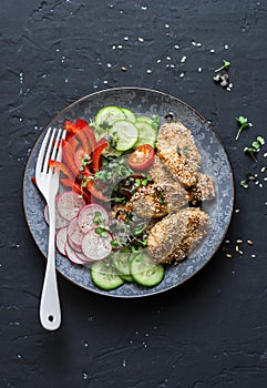 Sesame breading teriyaki baked chicken breast and fresh vegetables. Baked chicken and tomatoes, cucumbers, peppers, radishes, micr photo
