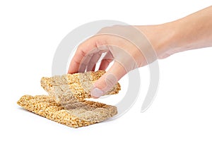 Sesame brittles brick in hand Isolated on white background.