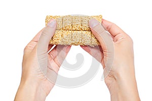 Sesame brittles brick in hand Isolated on white background.