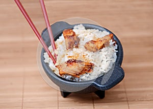 Sesame chicken in a black bowl