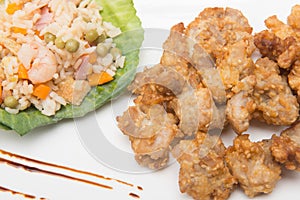 Sesame chicken dish and chopsticks on bamboo placemat photo