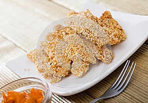Sesame crusted chicken fingers with sauce
