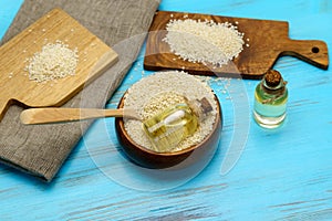 Sesame oil in a glass jar and sesame seeds. Uncooked sesame background concept. Selective focus