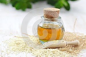 Sesame oil in glass and seeds