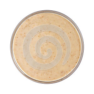 Sesame sauce. Tahini in bowl isolated on white background. Top view