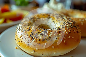 A sesame seed bagel sits on a white plate