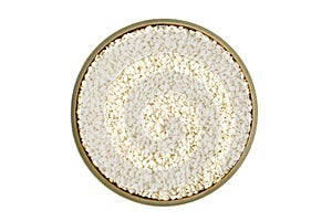 Sesame seeds in a bowl solated on white