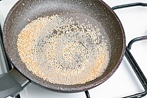 Sesame seeds are fried in the pan