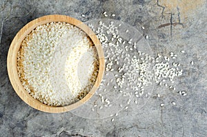 Sesame seeds in wooden bolw on vintage backgrounds above