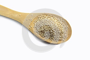 Sesame seeds on a wooden spoon isolated