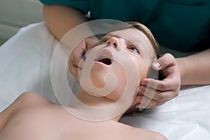 Session of craniosacral therapy, cure of teen boy& x27;s jaw by a doctor therapist.