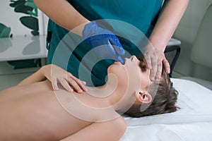 Session of craniosacral therapy, cure of teen boy& x27;s jaws by a doctor therapist.