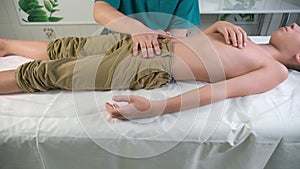 Session of craniosacral therapy, cure of teen boy's stomach by doctor therapist.